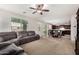 Open concept living and dining area featuring a large sectional sofa and tile flooring in the dining area at 1876 E Azalea Ct, Gilbert, AZ 85298