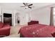 Comfortable main bedroom offering nice closet space, with a couch, ceiling fan, and access to the main bathroom at 1876 E Azalea Ct, Gilbert, AZ 85298