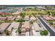 Aerial view of the neighborhood with a high school athletic field, residential homes, and community amenities at 1876 E Azalea Ct, Gilbert, AZ 85298