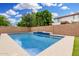 Sparkling blue pool is surrounded by a concrete deck and complemented by lush green landscaping at 1876 E Azalea Ct, Gilbert, AZ 85298