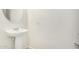 Small powder room featuring a pedestal sink, neutral walls, and minimalist design at 1876 E Azalea Ct, Gilbert, AZ 85298