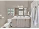 Bathroom with a double sink vanity, tiled floors, and a framed mirror at 1882 W Wildhorse Dr, Chandler, AZ 85286
