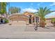 Charming single-story home with stucco facade, tile roof, desert landscaping, and attached two-car garage at 1882 W Wildhorse Dr, Chandler, AZ 85286