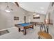Well-lit game room with a pool table, shuffleboard, stylish bar stools and contemporary lighting at 1882 W Wildhorse Dr, Chandler, AZ 85286