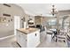 Open-concept kitchen with granite countertops, white cabinets, and easy access to the living room at 1882 W Wildhorse Dr, Chandler, AZ 85286
