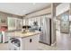 Open kitchen features granite countertops, white cabinets, a center island with seating, and stainless steel appliances at 1882 W Wildhorse Dr, Chandler, AZ 85286