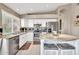 Bright kitchen with white cabinetry, granite countertops, stainless steel appliances, and center island seating at 1882 W Wildhorse Dr, Chandler, AZ 85286