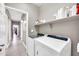 Laundry room with front-loading washer and dryer units and storage at 1882 W Wildhorse Dr, Chandler, AZ 85286