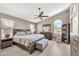 Bright main bedroom featuring tile floors, ceiling fan, and a large window at 1882 W Wildhorse Dr, Chandler, AZ 85286