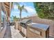 Backyard outdoor kitchen with built-in grill at 1882 W Wildhorse Dr, Chandler, AZ 85286