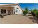 Paved backyard with lush shrubbery, offering a serene outdoor setting at 20424 N 96Th Ln, Peoria, AZ 85382
