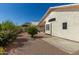 Exterior view of a backyard with brick pavers and well-maintained shrubs and landscaping at 20424 N 96Th Ln, Peoria, AZ 85382