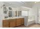 Well-lit bathroom boasts double sinks, a tub, a walk in shower, and plenty of storage at 20424 N 96Th Ln, Peoria, AZ 85382