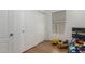 Hardwood floors in a bedroom with a double-door closet and a bed at 20424 N 96Th Ln, Peoria, AZ 85382