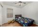Comfortable bedroom with hardwood floors, ceiling fan, and a modern metal bedframe at 20424 N 96Th Ln, Peoria, AZ 85382