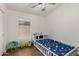 Cozy bedroom with hardwood floors, a ceiling fan, and a twin bed for a  at 20424 N 96Th Ln, Peoria, AZ 85382