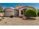 Charming single-story home featuring a two-car garage and desert landscaping at 20424 N 96Th Ln, Peoria, AZ 85382