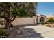 Charming single-story home featuring a two-car garage and desert landscaping at 20424 N 96Th Ln, Peoria, AZ 85382