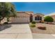 Charming single-story home featuring a two-car garage and desert landscaping at 20424 N 96Th Ln, Peoria, AZ 85382