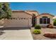 Charming single-story home featuring a two-car garage and desert landscaping at 20424 N 96Th Ln, Peoria, AZ 85382
