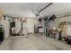 Functional garage featuring shelving, a small refrigerator, and ample storage options at 20424 N 96Th Ln, Peoria, AZ 85382