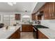 Traditional kitchen features a kitchen island with marble countertops and wooden cabinetry at 20424 N 96Th Ln, Peoria, AZ 85382