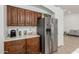 Functional kitchen features stainless steel appliances, wood cabinets, and light countertops at 20424 N 96Th Ln, Peoria, AZ 85382