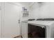 Laundry room featuring modern washer and dryer units, along with storage shelves at 20424 N 96Th Ln, Peoria, AZ 85382
