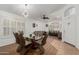 Open-concept dining and living room with a decorative chandelier and shuttered windows at 20424 N 96Th Ln, Peoria, AZ 85382