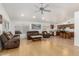 Open-concept living area with hardwood floors connecting to kitchen with bar seating at 20424 N 96Th Ln, Peoria, AZ 85382