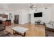 Open-concept living area with hardwood floors connecting to kitchen with bar seating at 20424 N 96Th Ln, Peoria, AZ 85382