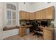 Office space features built-in desk, window seat, and modern rolling chair at 20424 N 96Th Ln, Peoria, AZ 85382