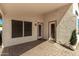 Covered patio space with brick flooring, offering a secluded outdoor area at 20424 N 96Th Ln, Peoria, AZ 85382