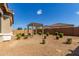 Landscaped backyard featuring a pergola and desert landscaping at 21031 E Poco Calle St, Queen Creek, AZ 85142
