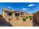 View of the home's private backyard featuring a pergola, desert landscaping, and block wall at 21031 E Poco Calle St, Queen Creek, AZ 85142