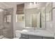 Modern bathroom with a gray vanity, white countertop, and a glass-enclosed shower at 21031 E Poco Calle St, Queen Creek, AZ 85142