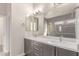 Elegant bathroom with a double vanity, modern fixtures, and a large mirror reflecting the shower at 21031 E Poco Calle St, Queen Creek, AZ 85142