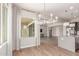 Bright dining area with modern chandelier and view of the open living spaces at 21031 E Poco Calle St, Queen Creek, AZ 85142