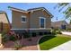 Beautiful home exterior with artificial turf, decorative rock, and mature landscaping at 21031 E Poco Calle St, Queen Creek, AZ 85142