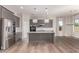 Bright, open kitchen featuring a large island with gray cabinets and stainless steel appliances at 21031 E Poco Calle St, Queen Creek, AZ 85142