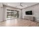 Stylish living room boasts a decorative stone wall, built-in cabinet, and sliding glass doors at 21031 E Poco Calle St, Queen Creek, AZ 85142