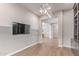 Bright living room featuring modern lighting and hardwood floors, creating an inviting space at 21031 E Poco Calle St, Queen Creek, AZ 85142
