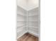 Walk-in pantry features white shelving and wood-look flooring at 21031 E Poco Calle St, Queen Creek, AZ 85142