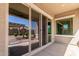 Large sliding glass doors connect indoor living to a covered patio and landscaped backyard at 21031 E Poco Calle St, Queen Creek, AZ 85142