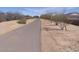 Scenic neighborhood walking path surrounded by desert landscaping and mature trees at 21031 E Poco Calle St, Queen Creek, AZ 85142