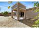 Covered patio opens to backyard with trees and plants at 21299 E Roundup Way, Queen Creek, AZ 85142