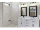 Modern bathroom with dual sinks, updated mirrors, and a tile shower at 21299 E Roundup Way, Queen Creek, AZ 85142