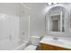 Bright bathroom with white tile shower and arched mirror above vanity at 21299 E Roundup Way, Queen Creek, AZ 85142
