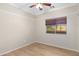 Well-lit bedroom with wood-look flooring and a ceiling fan at 21299 E Roundup Way, Queen Creek, AZ 85142