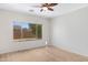 Bright bedroom featuring a large window and wood-look flooring at 21299 E Roundup Way, Queen Creek, AZ 85142